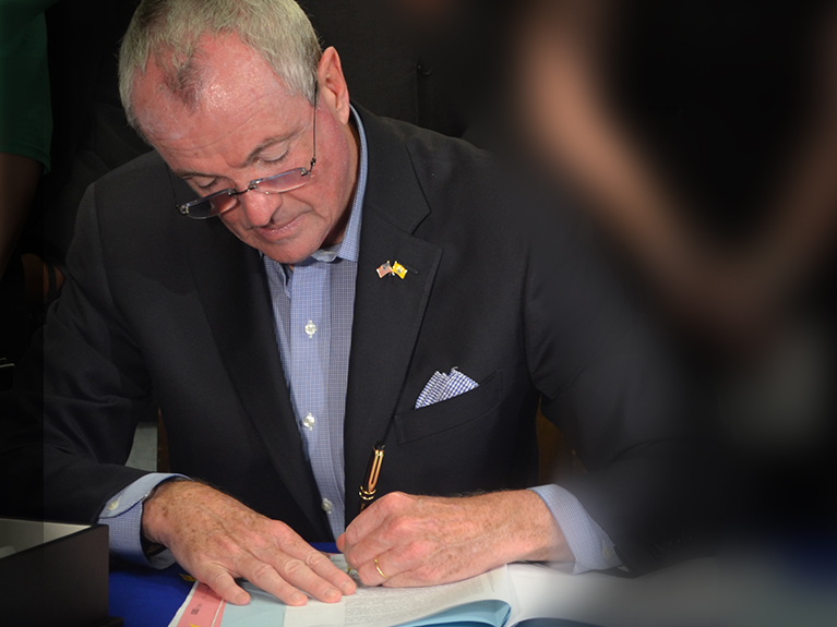New Jersey Governor Phil Murphy signing law
